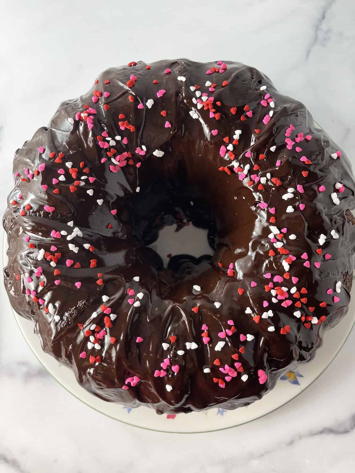 Chocolate glazed Bundt cake with sprinkles.