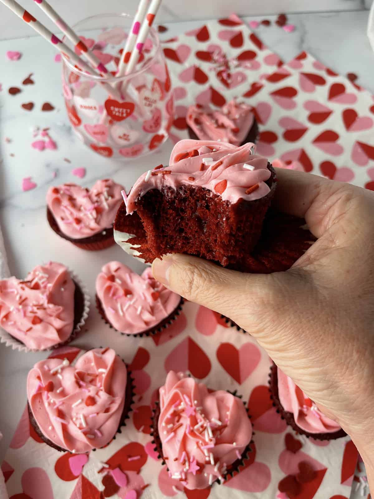 Red velvet cupcake with a bite taken out.