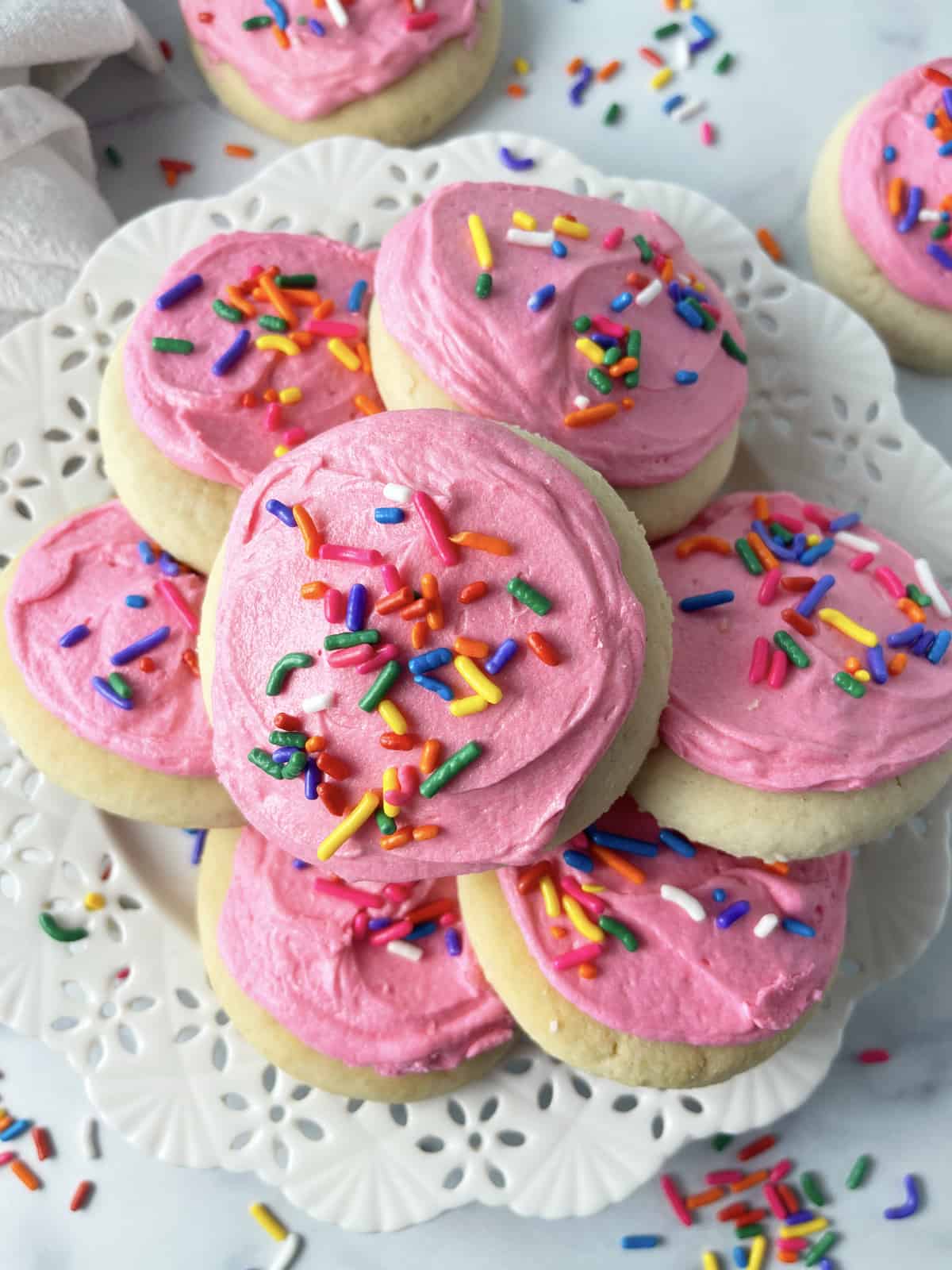 Copycat Lofthouse cookies piled high on a white plate.