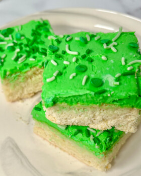 Sugar cookie bars in squares with green icing.