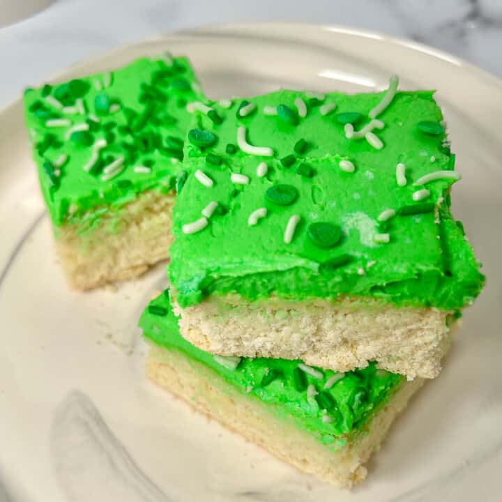 Sugar cookie bars in squares with green icing.