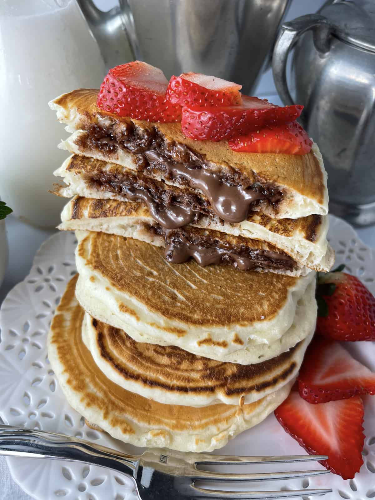 Nutella stuffed pancakes in a stack.