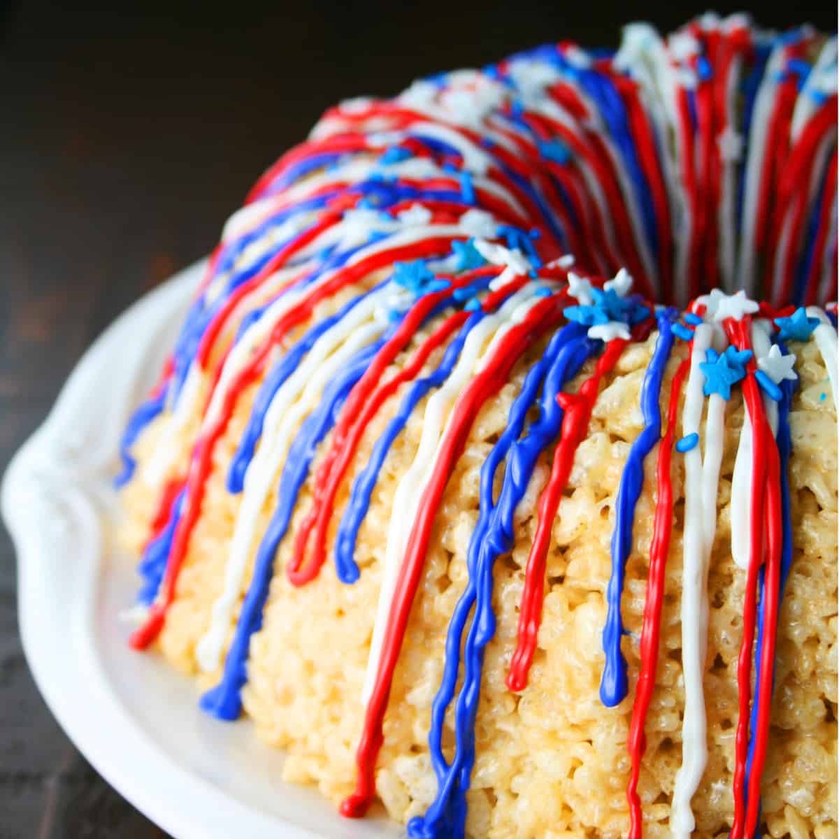 Rice krispy treats in the shape of a Bundt cake with chocolate drizzles.