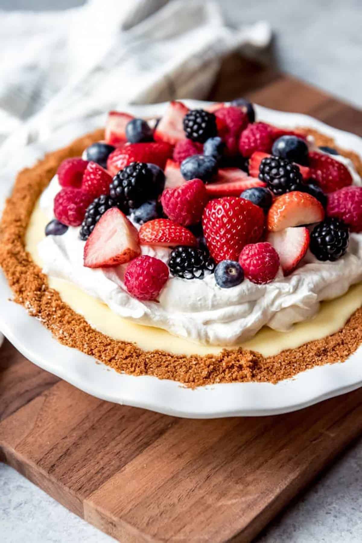 Cream pie with berries on top.