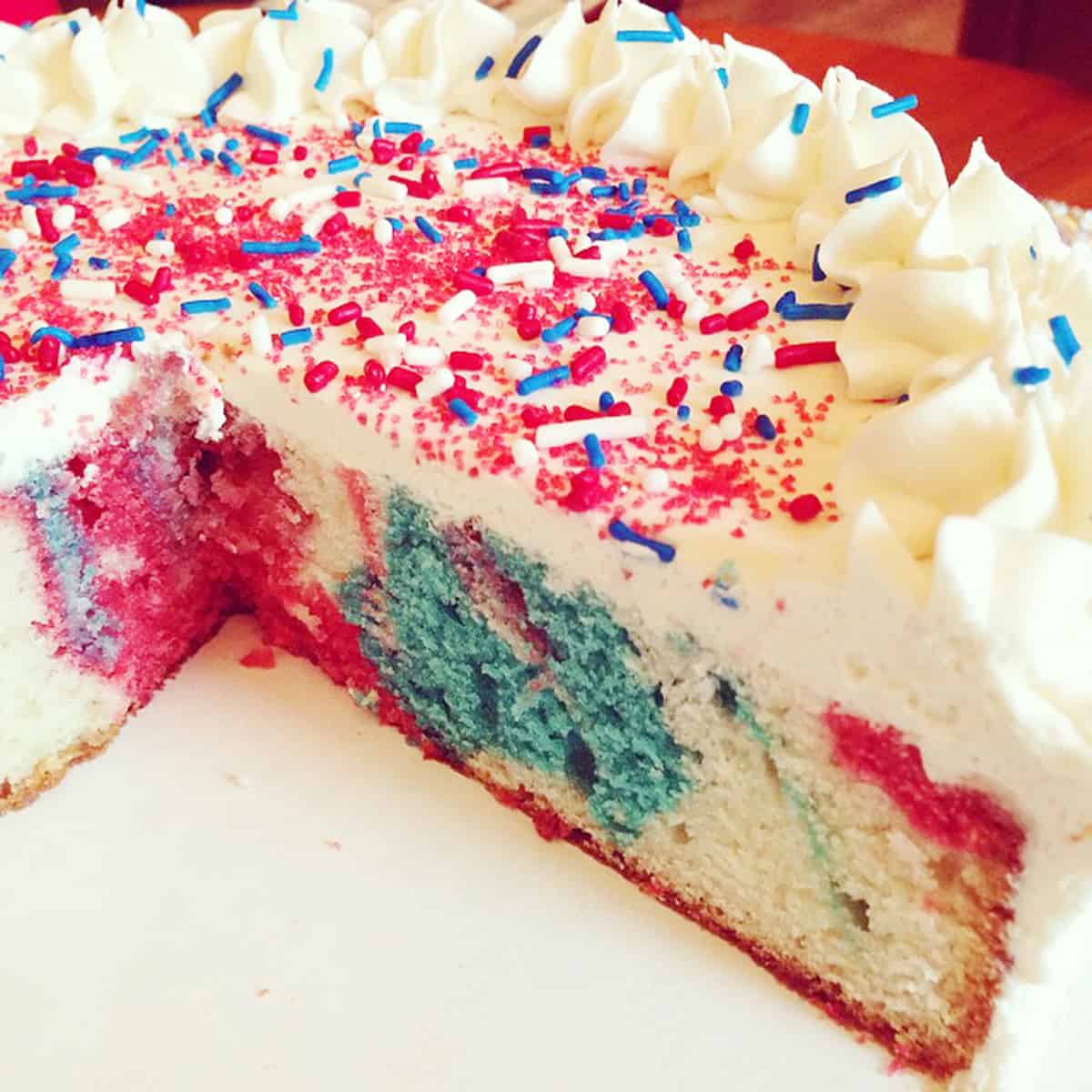 Red, white and blue tie dye cake with buttercream frosting.