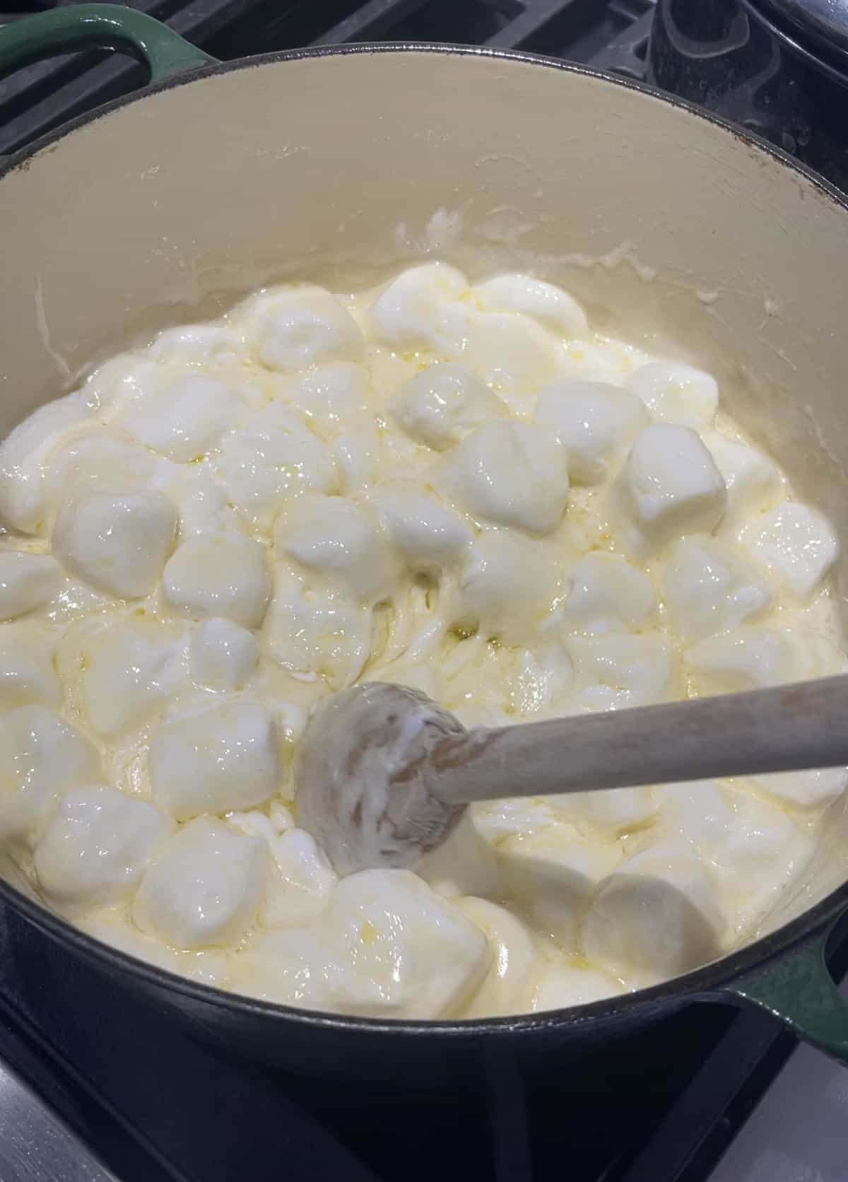 Jumbo marshmallows and butter in a large heavy sauce pan.