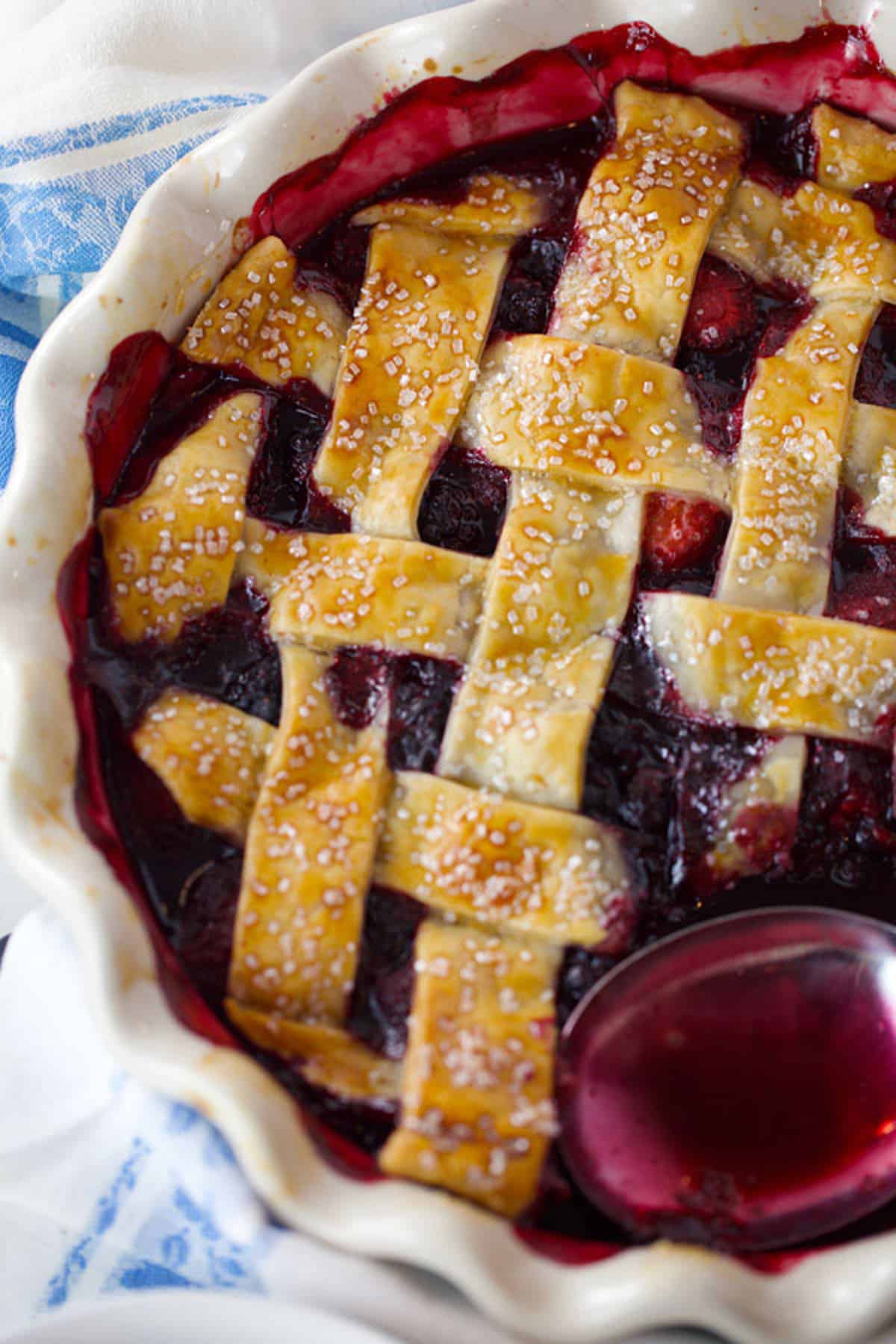 Mixed berries and blueberry cobbler in a round casserole dish from Pioneer Woman.