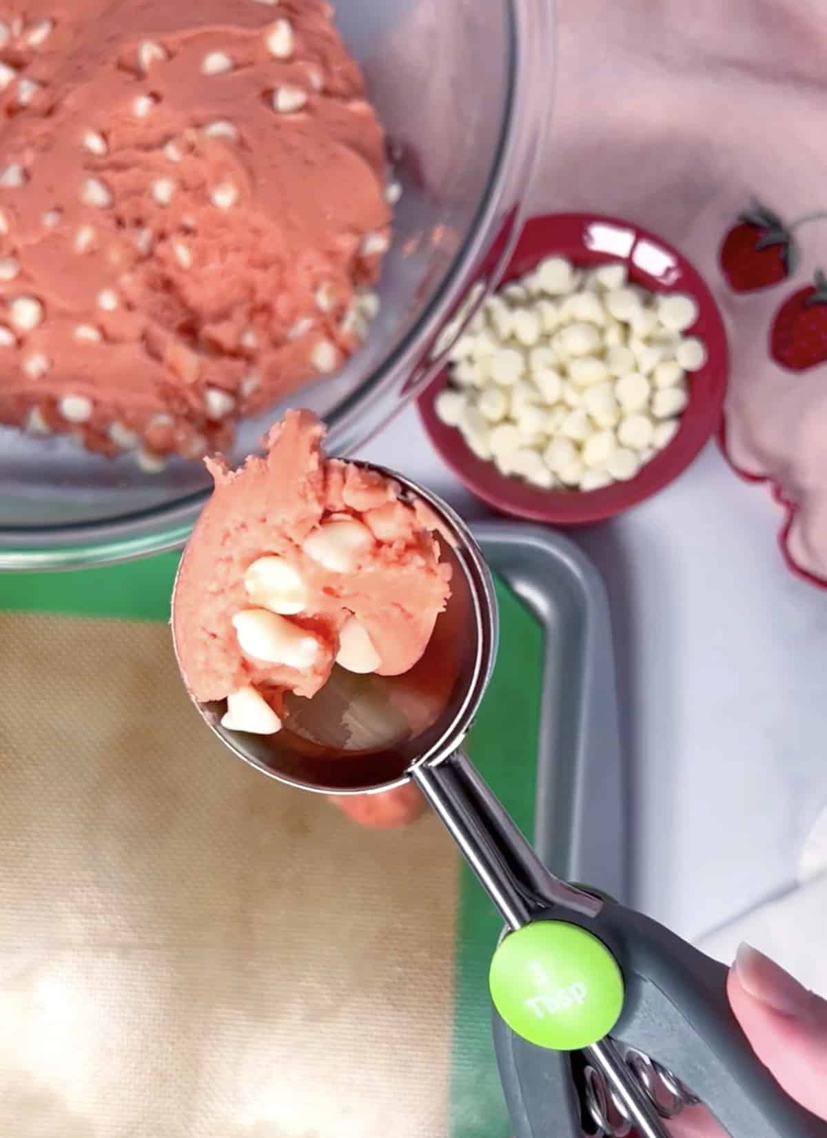 Using a cookie scoop to scoop cookie batter.