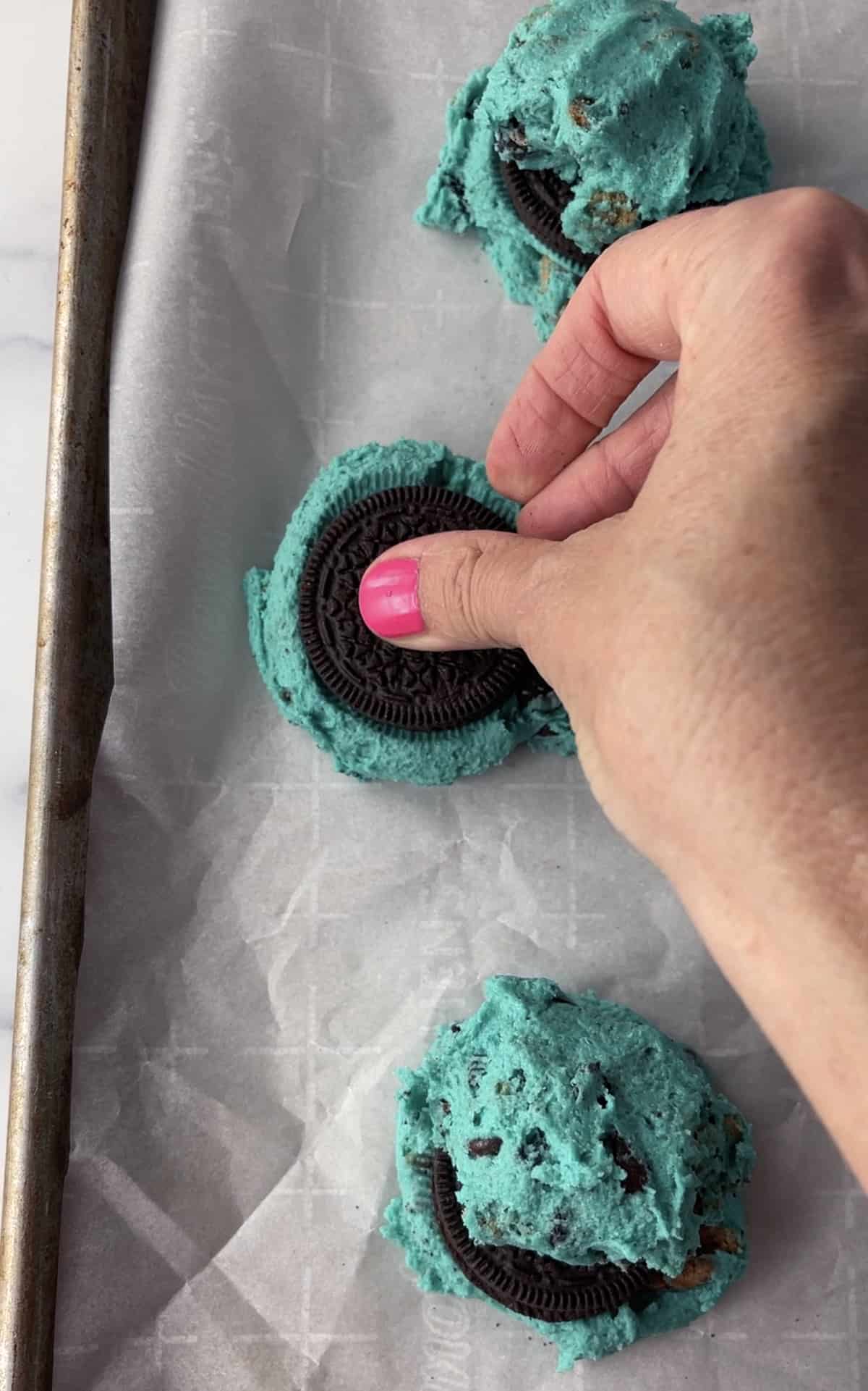 Place Oreo cookie on top of blue cookie dough.