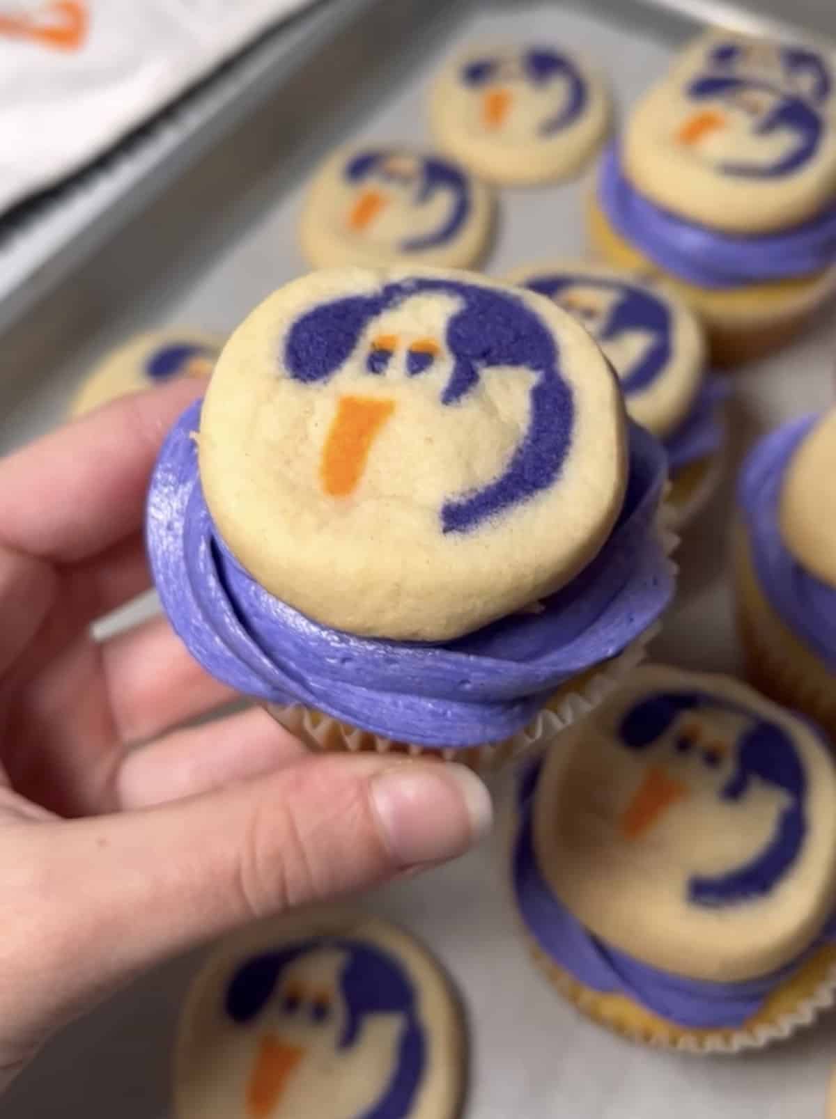 Purple cupcakes with Pillsbury Halloween cookies on top.