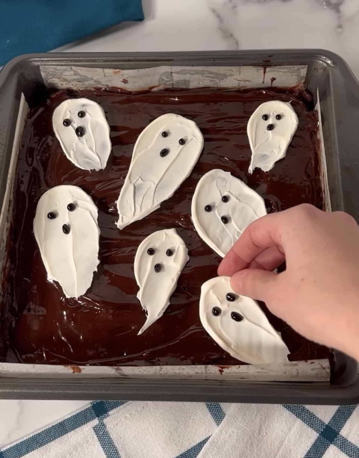 Ghost brownies in a pan.