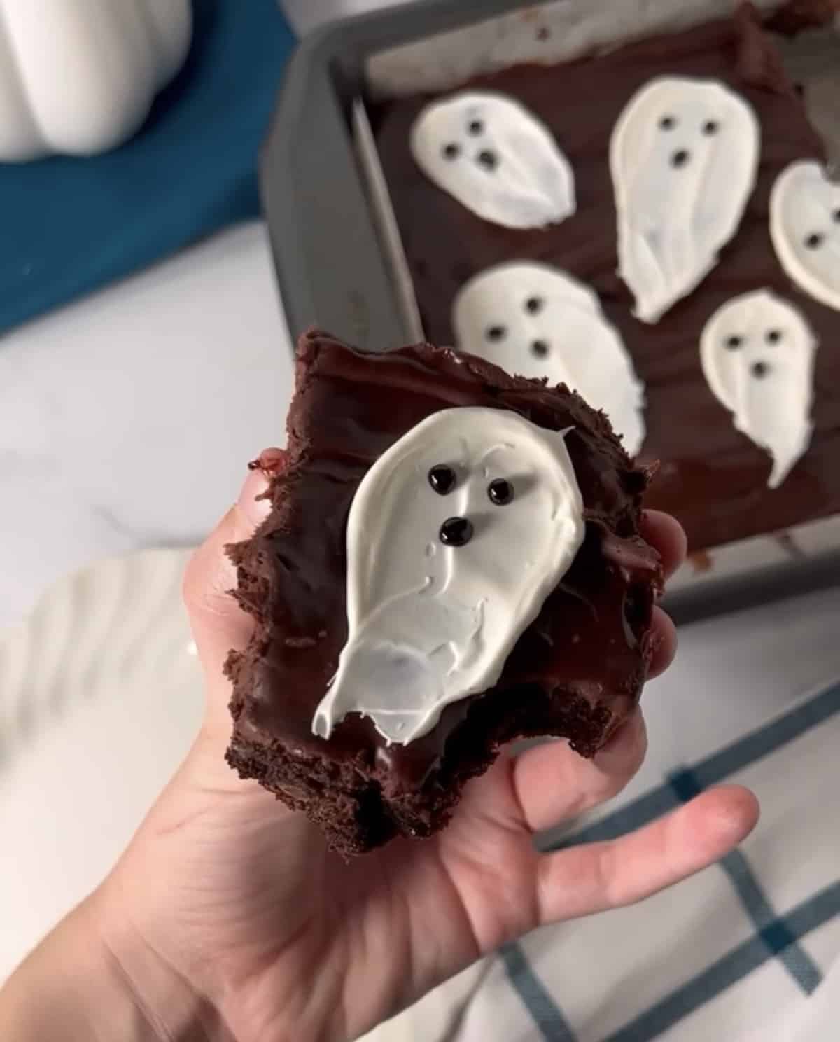 Halloween ghost brownie with bite taken out.