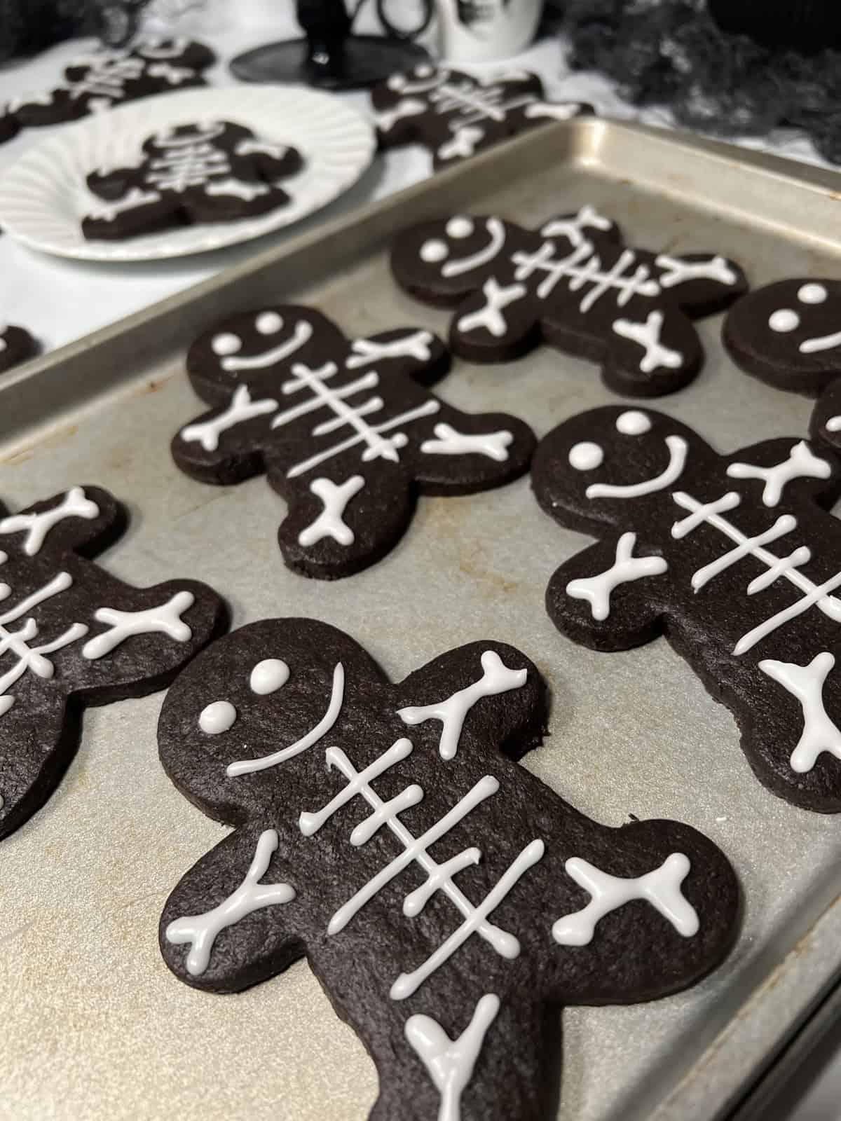 Halloween skeleton cookies on tray.