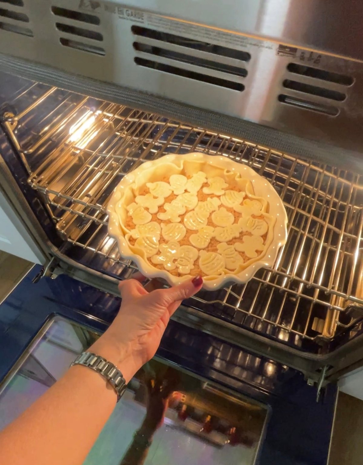 Placing brown sugar baked brie recipe in oven.