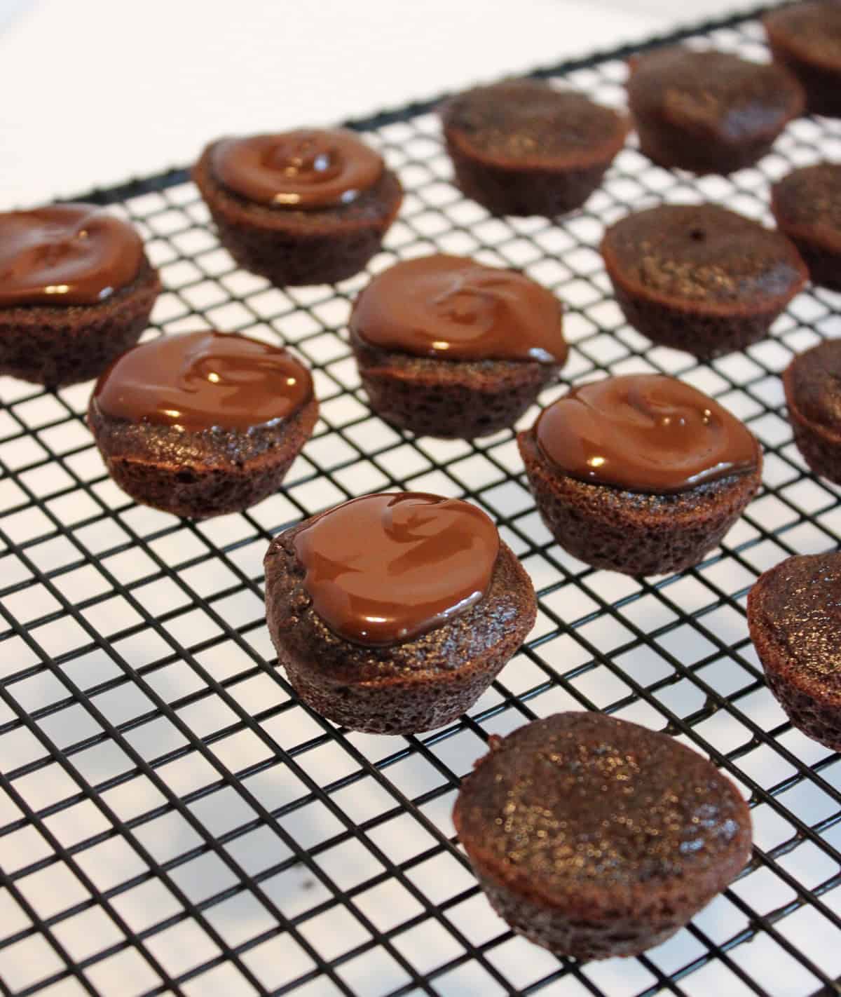 Mini cakes on a cooling rack.