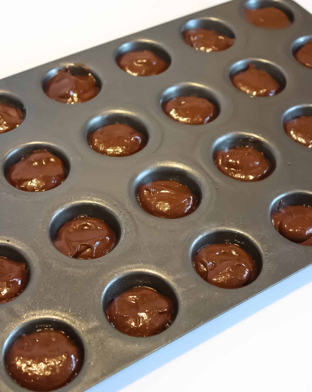 Cake batter in mini muffin pan.