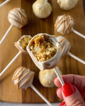 Pumpkin pie cake pop with bite out of it.