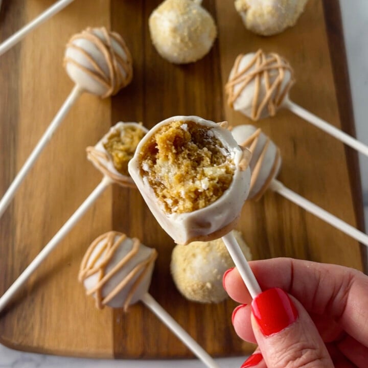 Pumpkin pie cake pop with bite out of it.