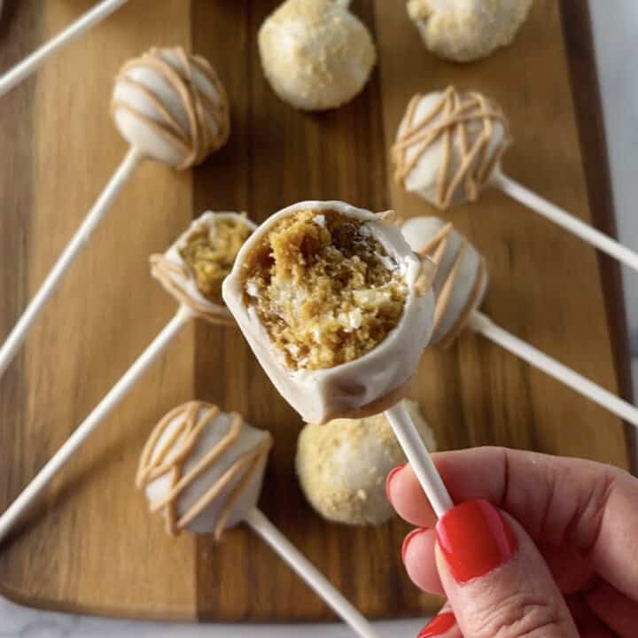 Pumpkin pie cake pop with bite out of it.