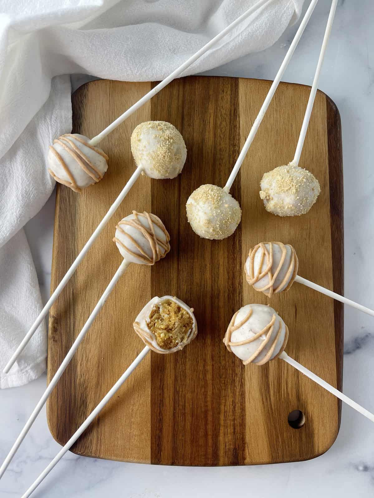 Easy pumpkin pie cake pops on cutting board.