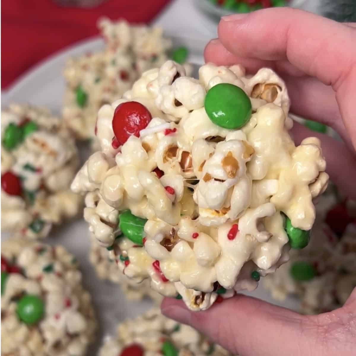 Christmas popcorn balls with green and red m and m candies.