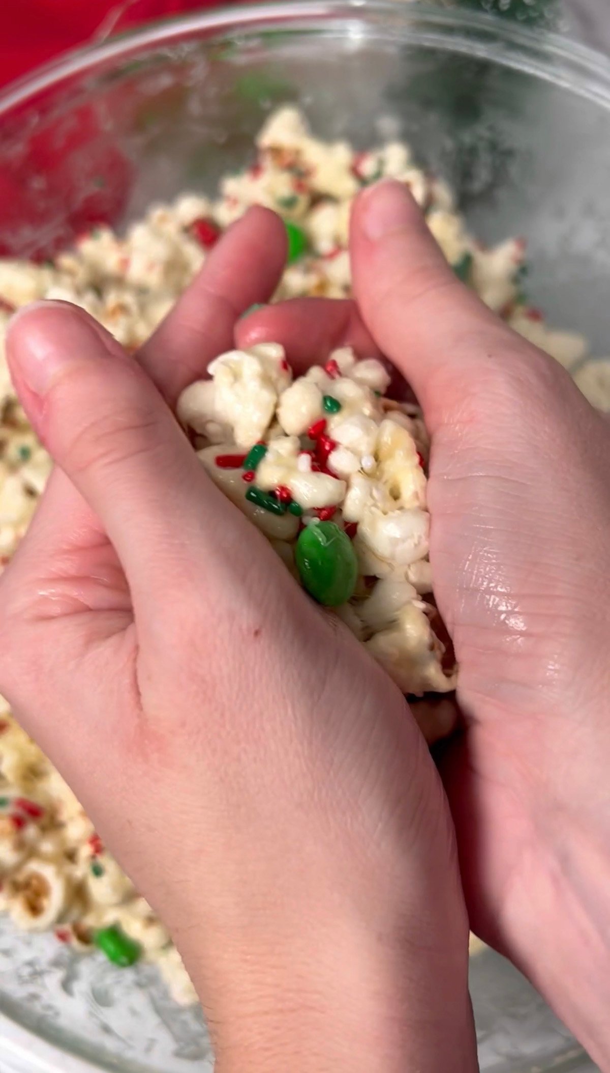 Forming popcorn balls with your hands.