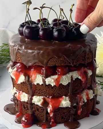 Easy black forest cake with fresh cherries on top.