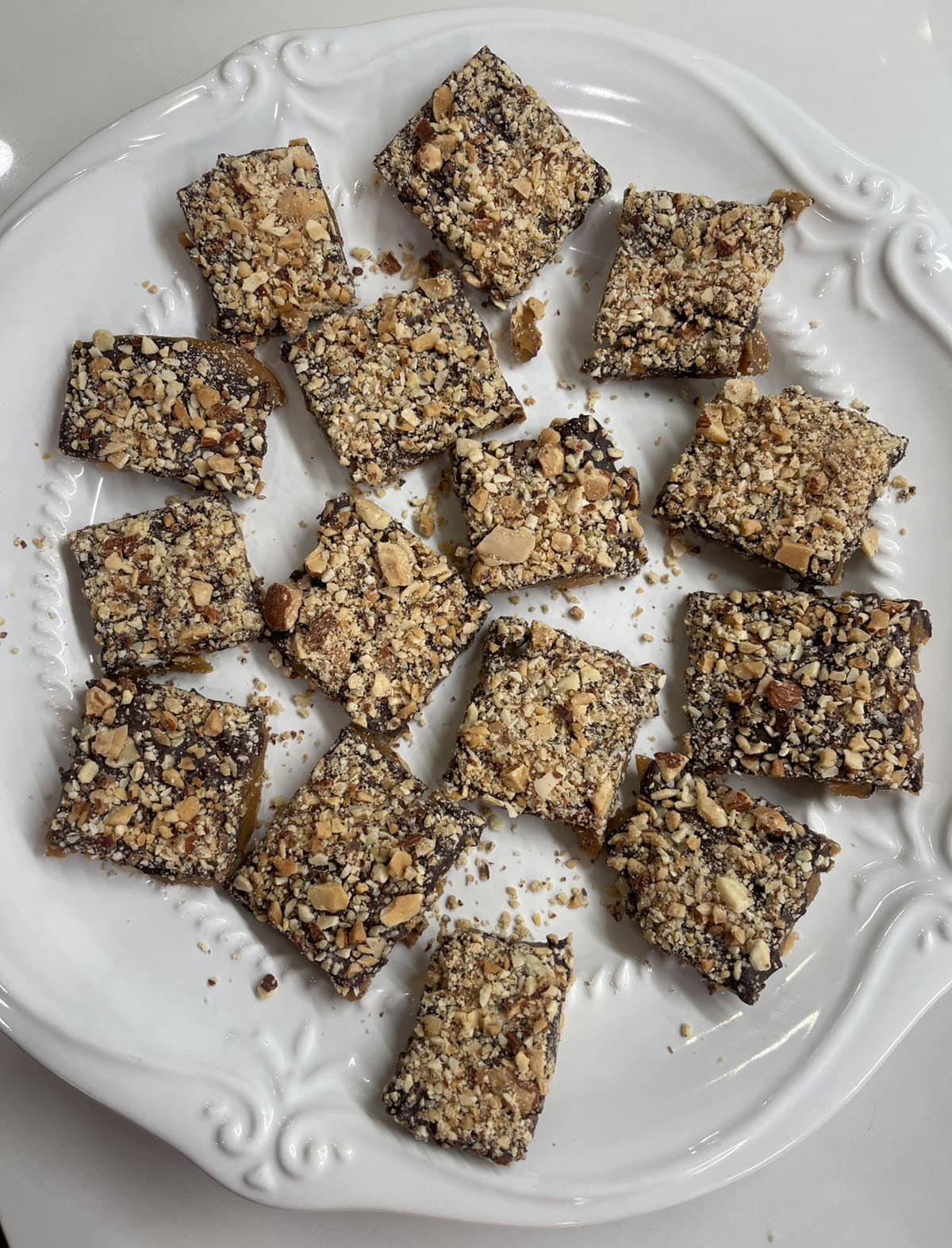 White plate with English toffee pieces.