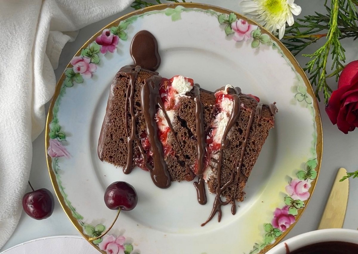 Slice of easy black forest cake on a pretty floral plate.