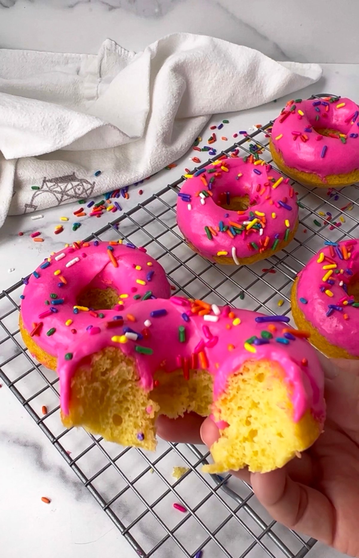 Vanilla frosted cake mix donuts with sprinkles.