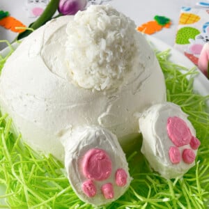 Cute bunny butt vanilla cake on a bed of green coconut grass.