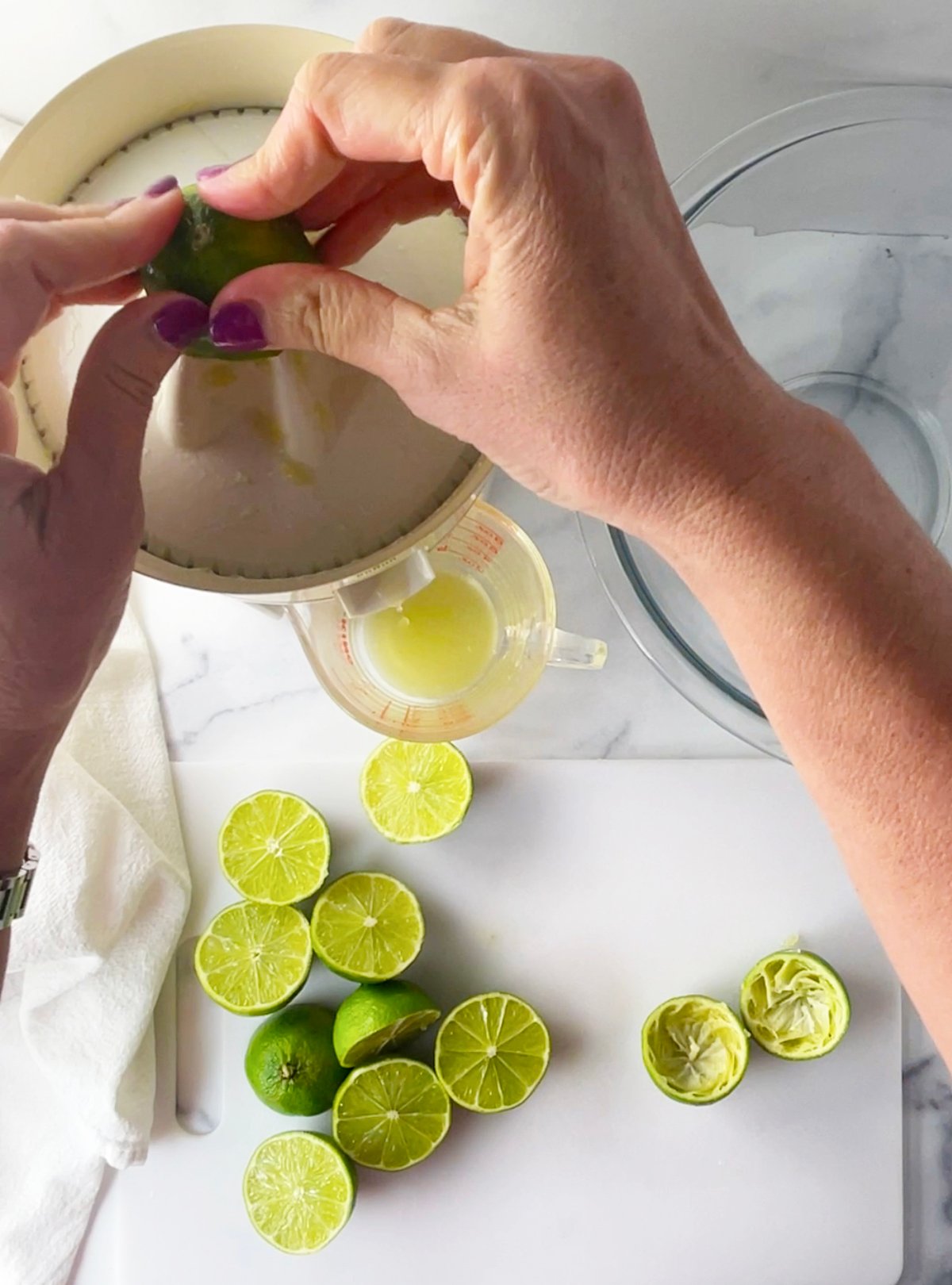 Juicing limes with and electric juicer.
