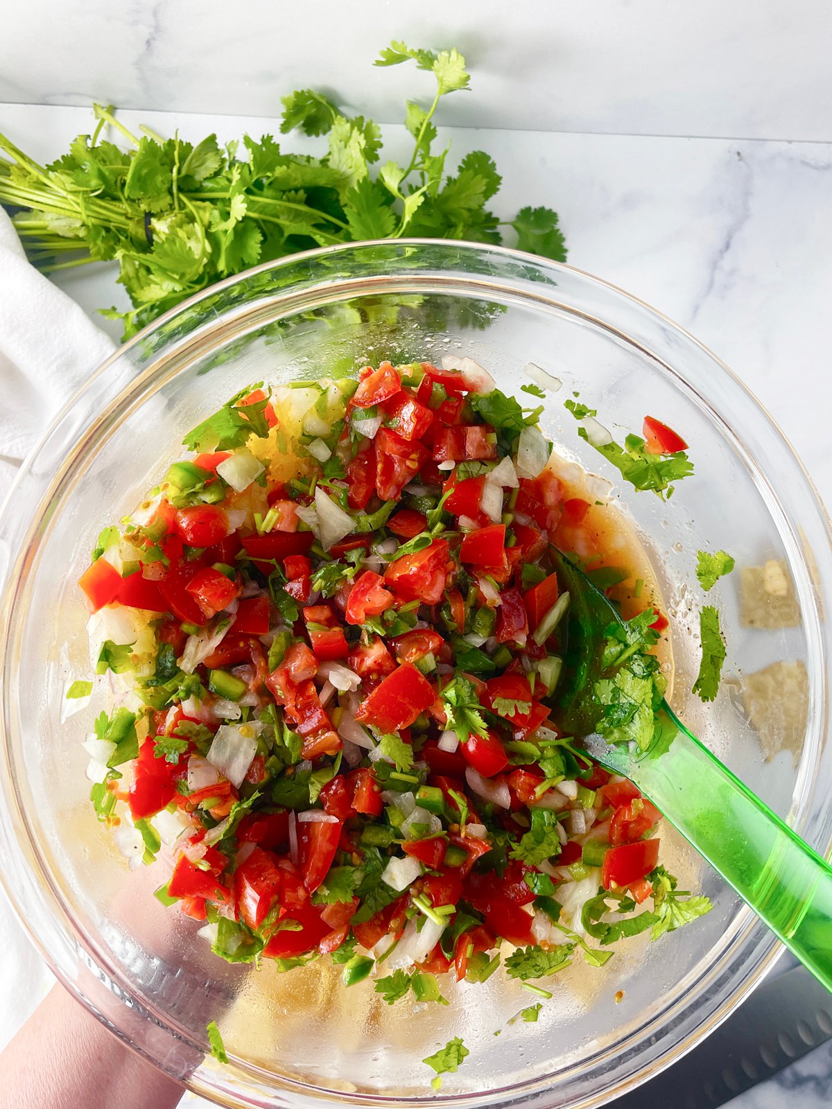 Delicious homemade salsa in a glass bowl.