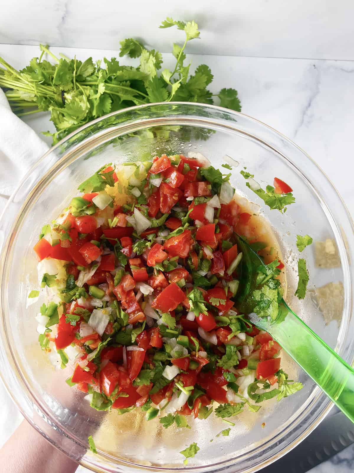 Delicious homemade salsa in a glass bowl.