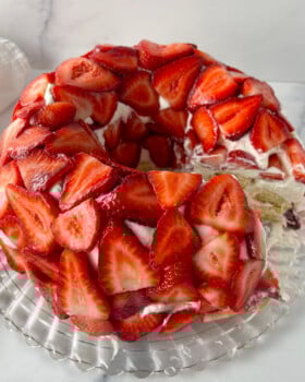 Tiramisu with Strawberries on a crystal cake platter.