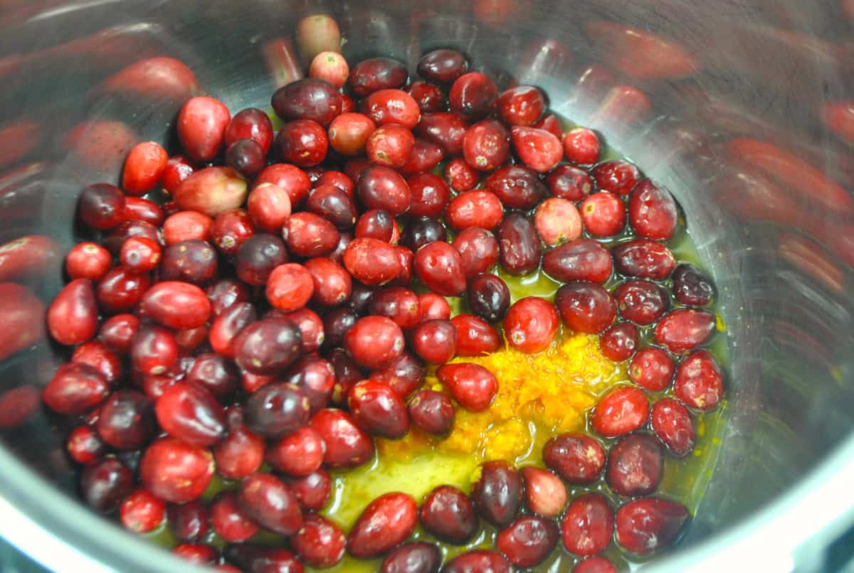 Whole cranberries and orange zest in the instant pot.