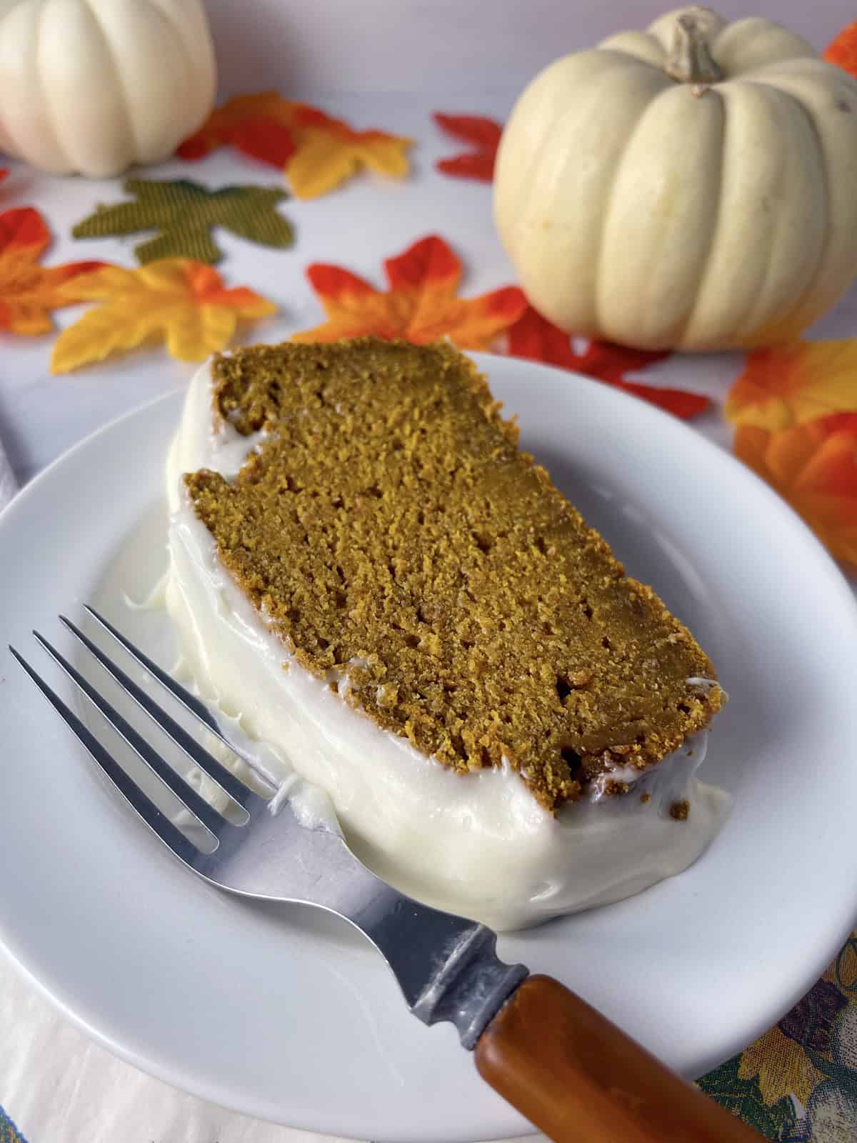 Slice of pumpkin cracker bread on a white plate.