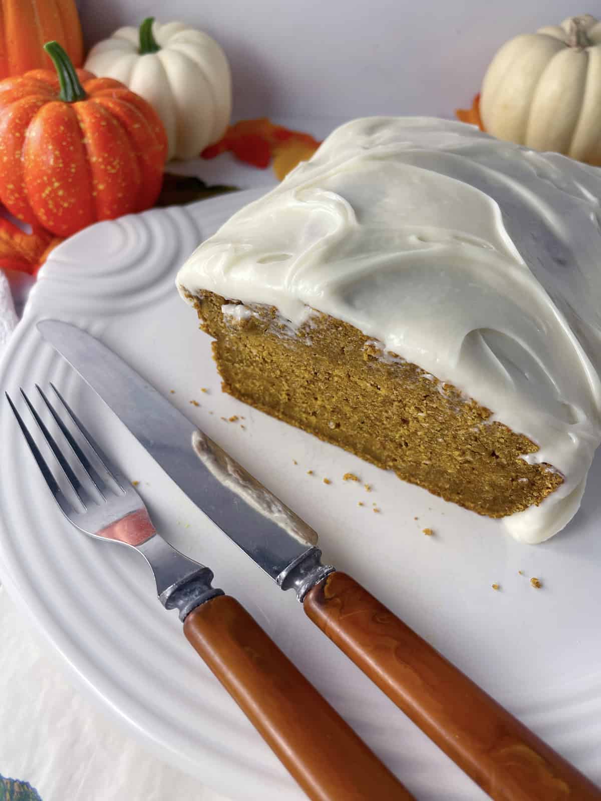 Sliced pumpkin bread on a white plate.