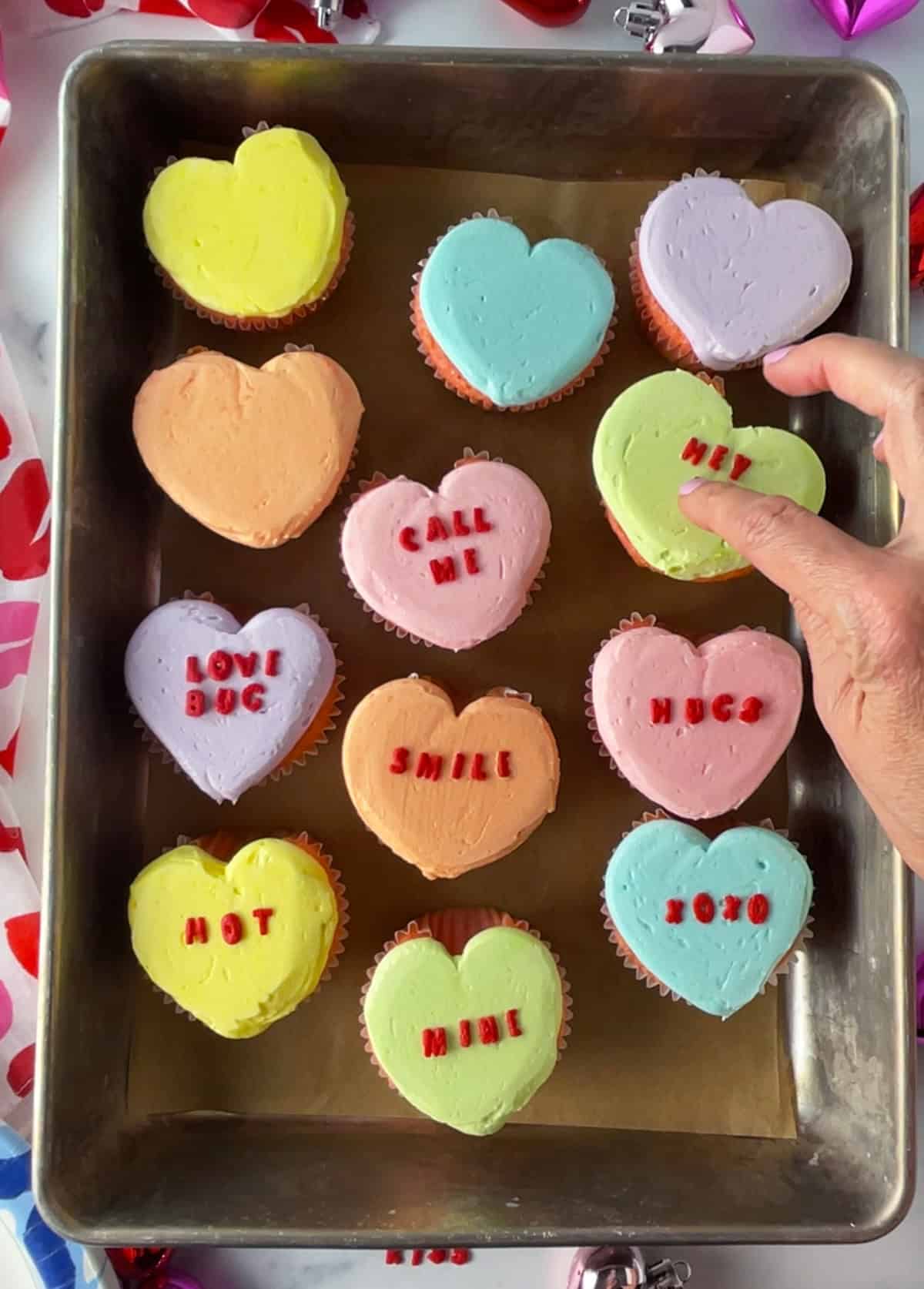 Conversation heart cupcakes in pan.