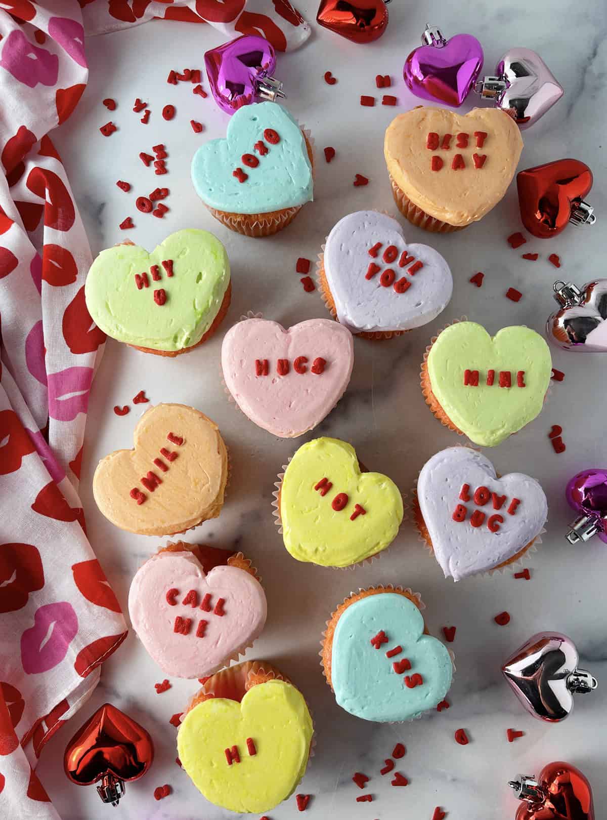 Strawberry cupcakes that look like heart shaped conversation heart candies.