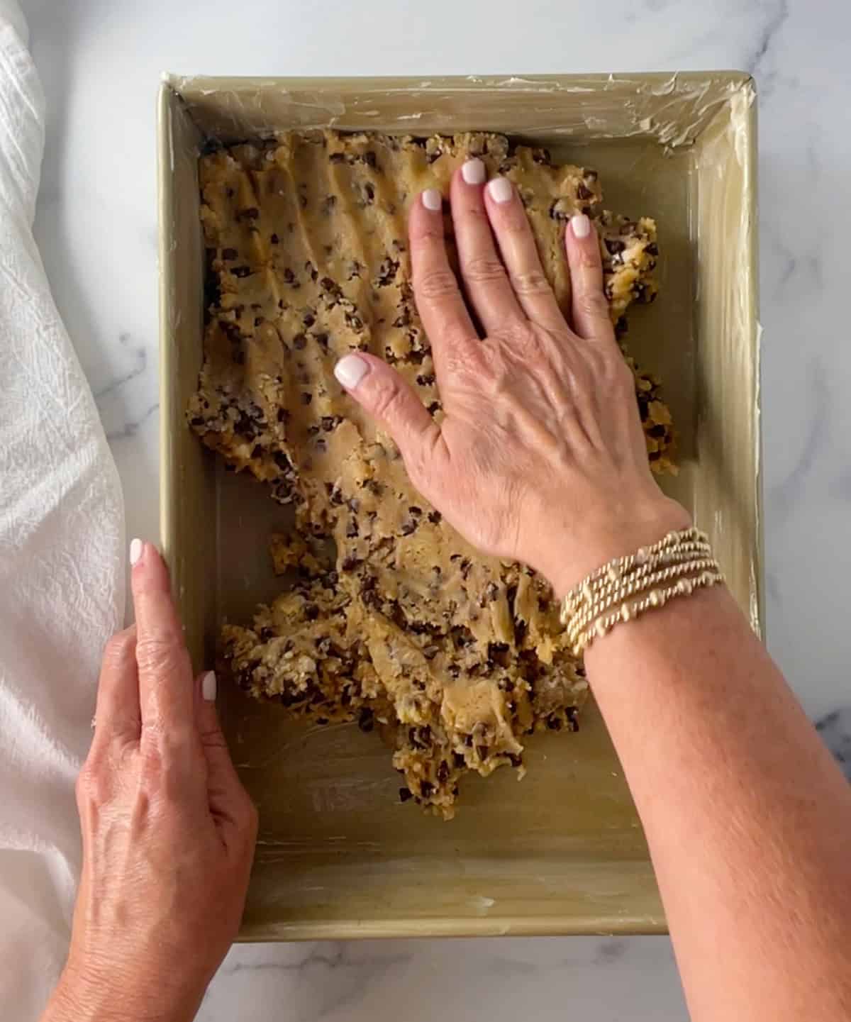 Pressing dough into pan.