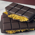 DIY Dubai chocolate bar with pistachio butter center and crunchy layers, split open.