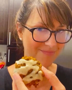 Baker Lise Ode holding a yummy iced pumpkin oatmeal cookie.