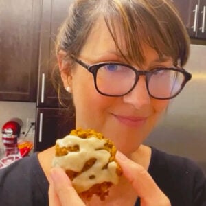 Baker Lise Ode holding a yummy iced pumpkin oatmeal cookie.