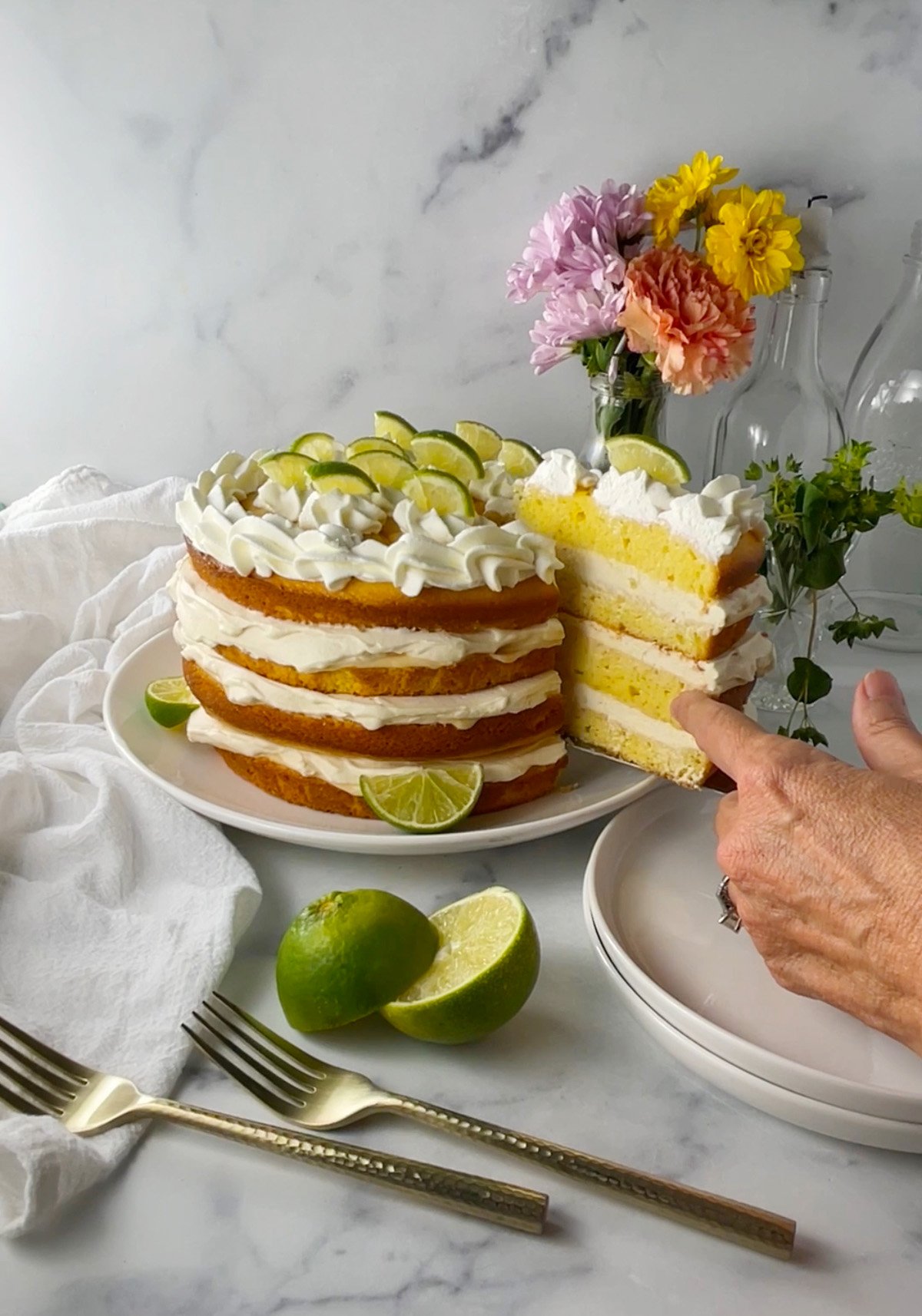 Close-up of moist key lime cake layers with creamy whipped filling and tangy lime flavor.