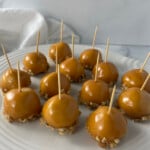 White plate filled with caramel apple cookies topped with drizzled caramel.