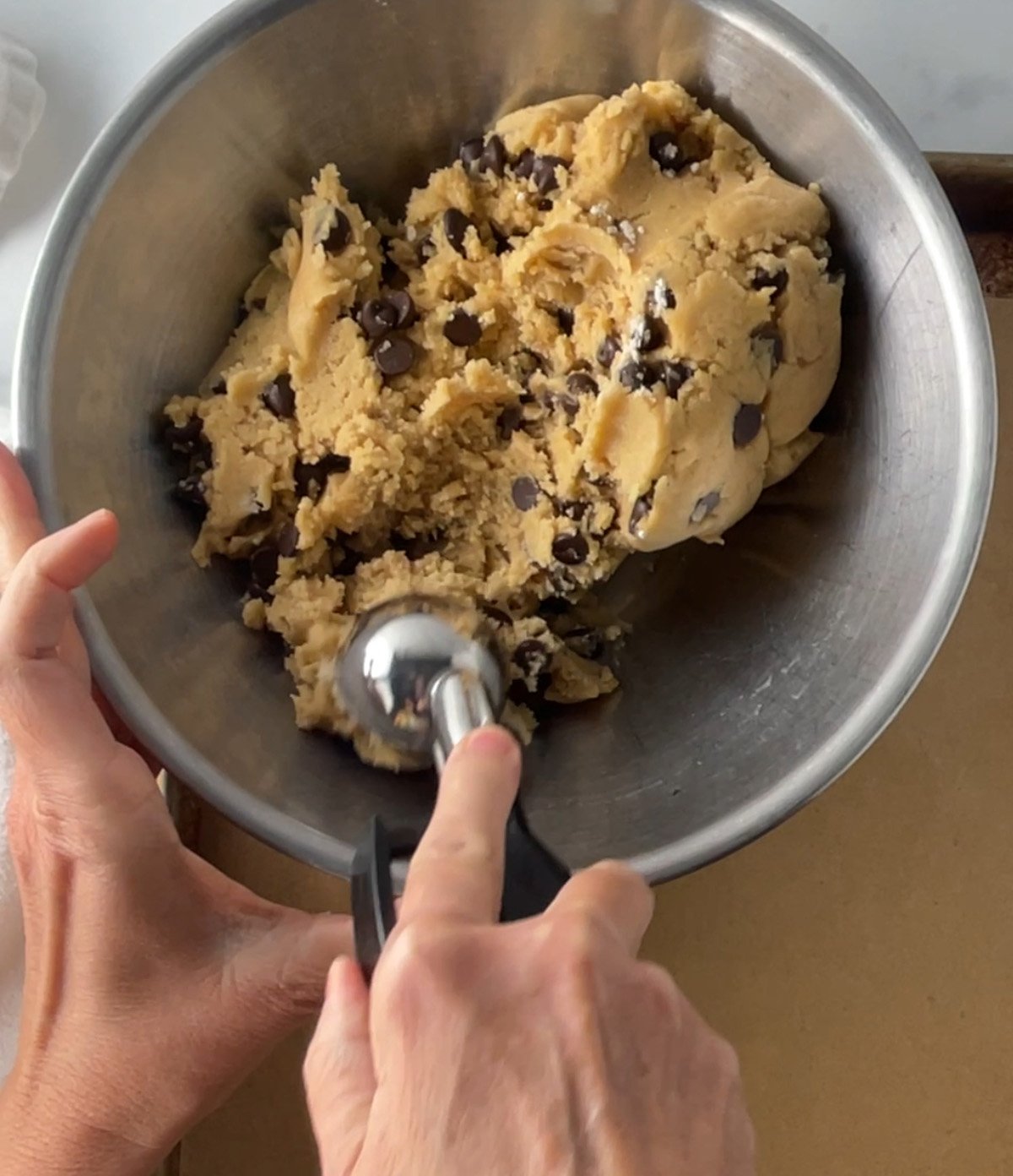 Scooping cookie dough onto baking tray.