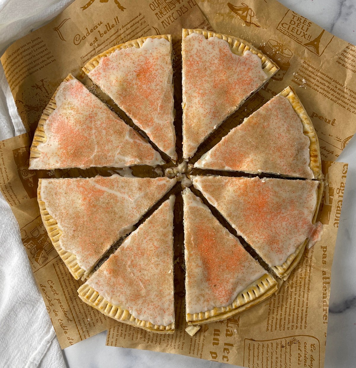 Completed homemade pumpkin pop tarts cut into eight triangles.