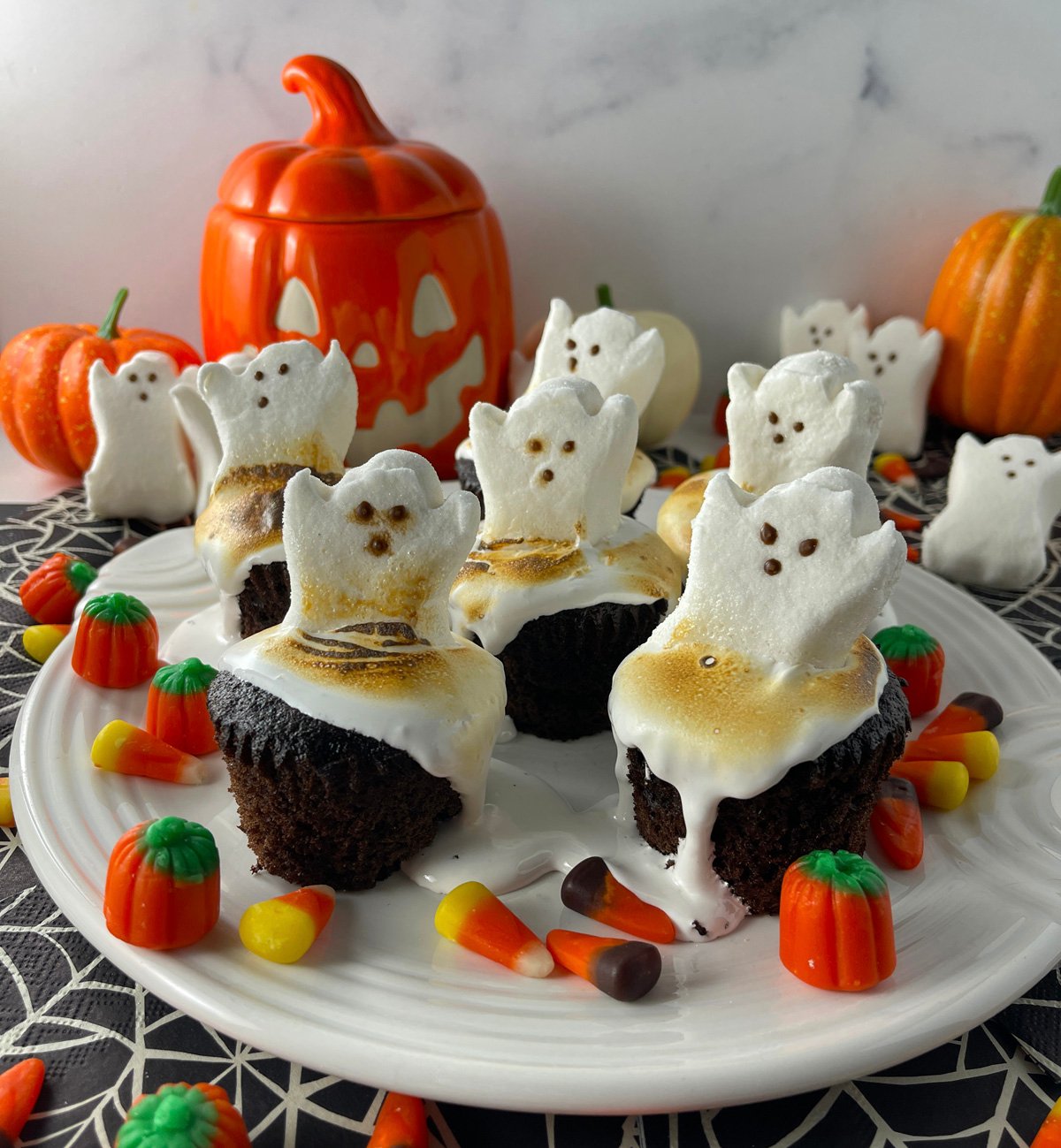 Easy ghost peep cupcakes on a white plate.