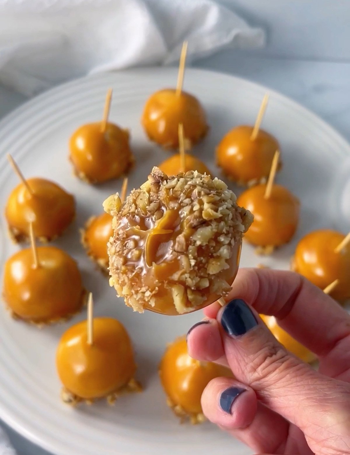 Caramel apple cookies dipped in crushed walnuts.